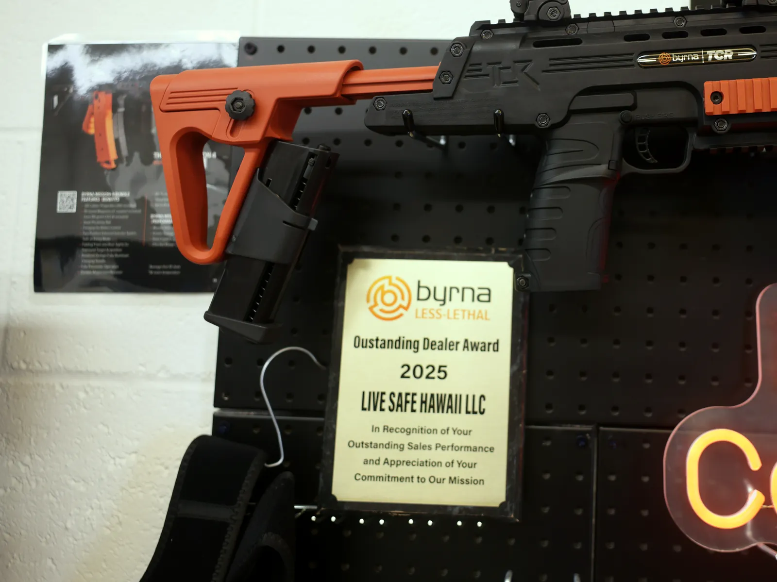 Byrna Outstanding Dealer Award 2025 plaque displayed in the shop